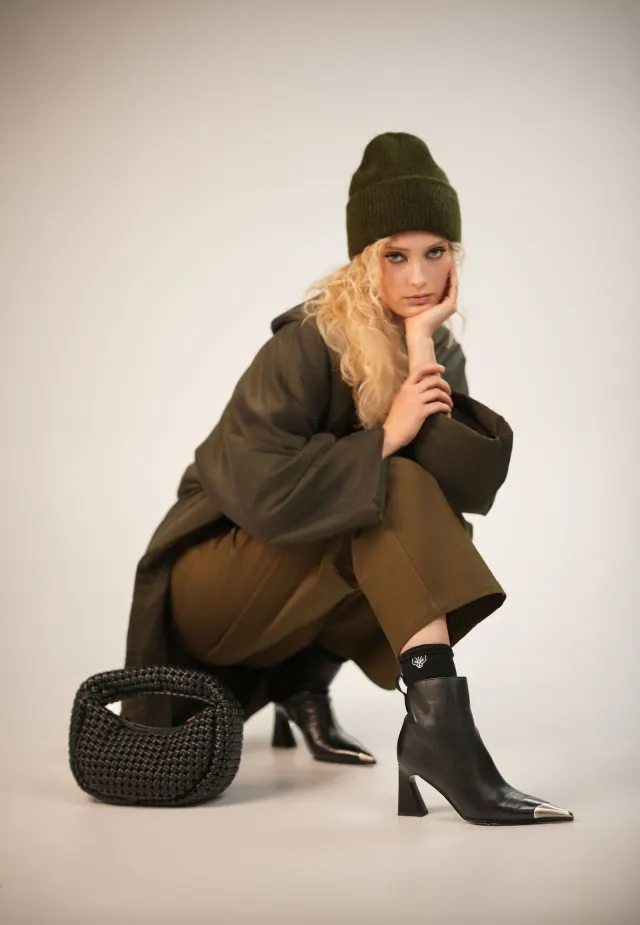 FOXXY black ankle boots with metal toe caps styled with an olive outfit and knit hat