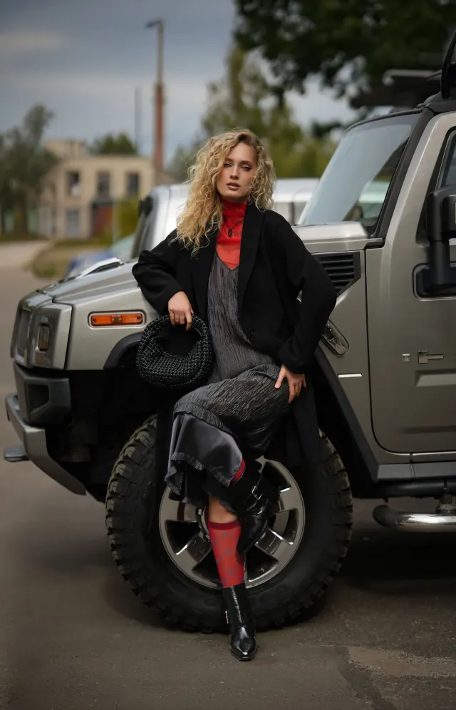 FOXXY black buckle ankle boots styled beside a silver off-road vehicle